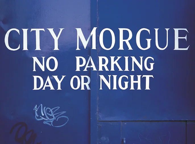 photo of blue plate metal gates of city morgue